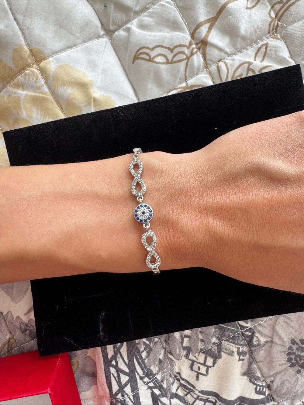 Sterling Silver Infinity Bracelet with Blue Crystal Accent